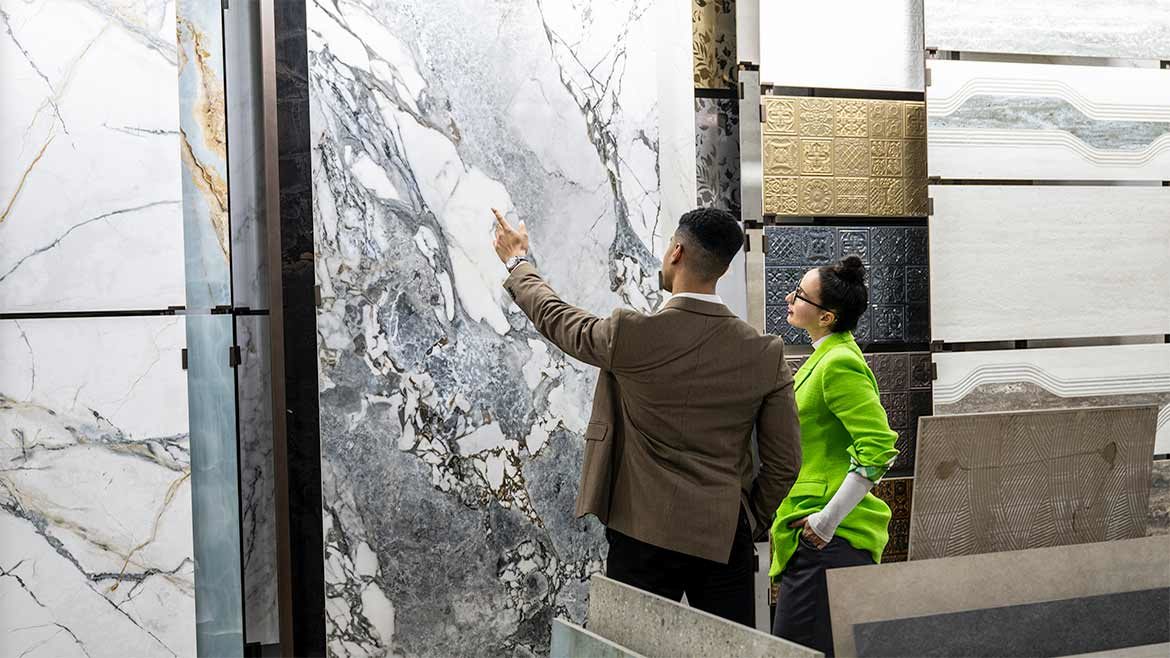 Two people looking at a slab in a showroom