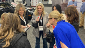 Women In Stone Amazing Race 2024 women huddled figuring out clue.