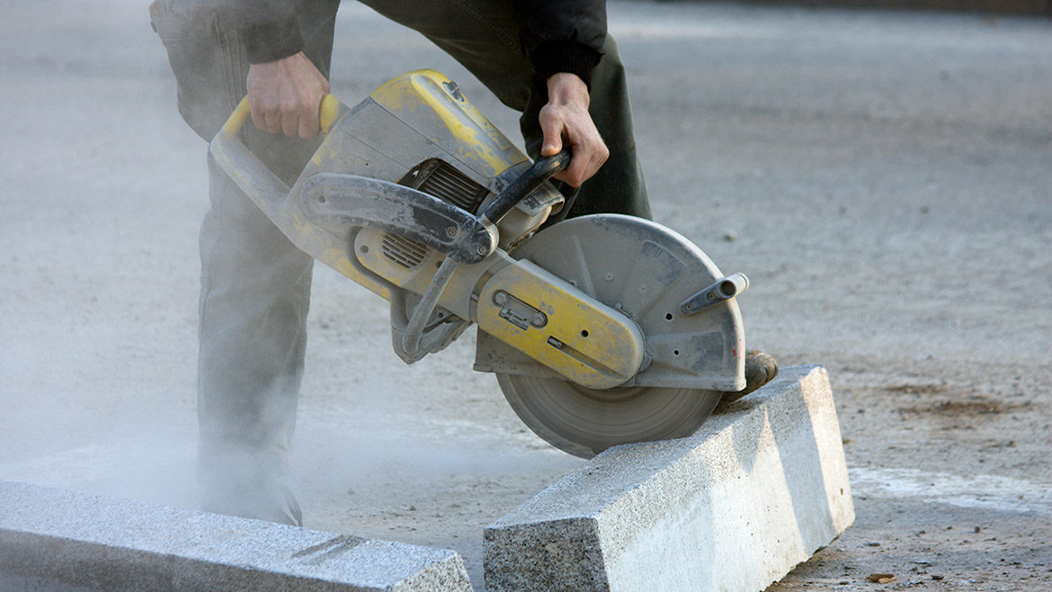 man slicing through stone